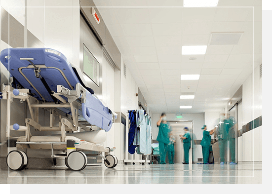 A hospital room with several doctors and nurses.