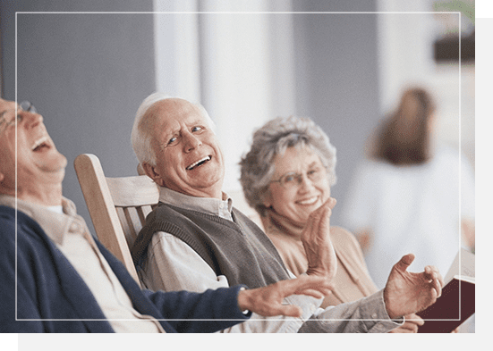 A man and woman sitting in chairs smiling.