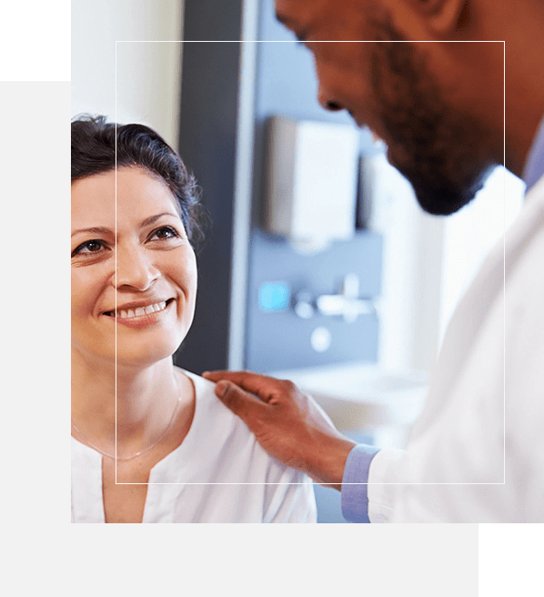 A doctor is talking to a woman in the hospital.