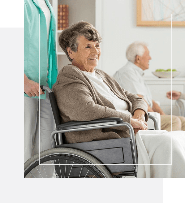 A woman in a wheelchair with two other people.