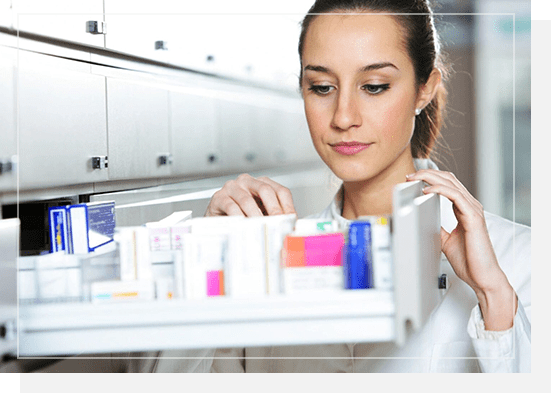 A woman looking at the medicine in her cabinet.